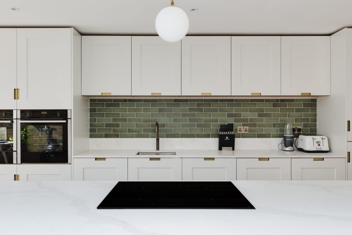 KItchen sink with green tiled splashback