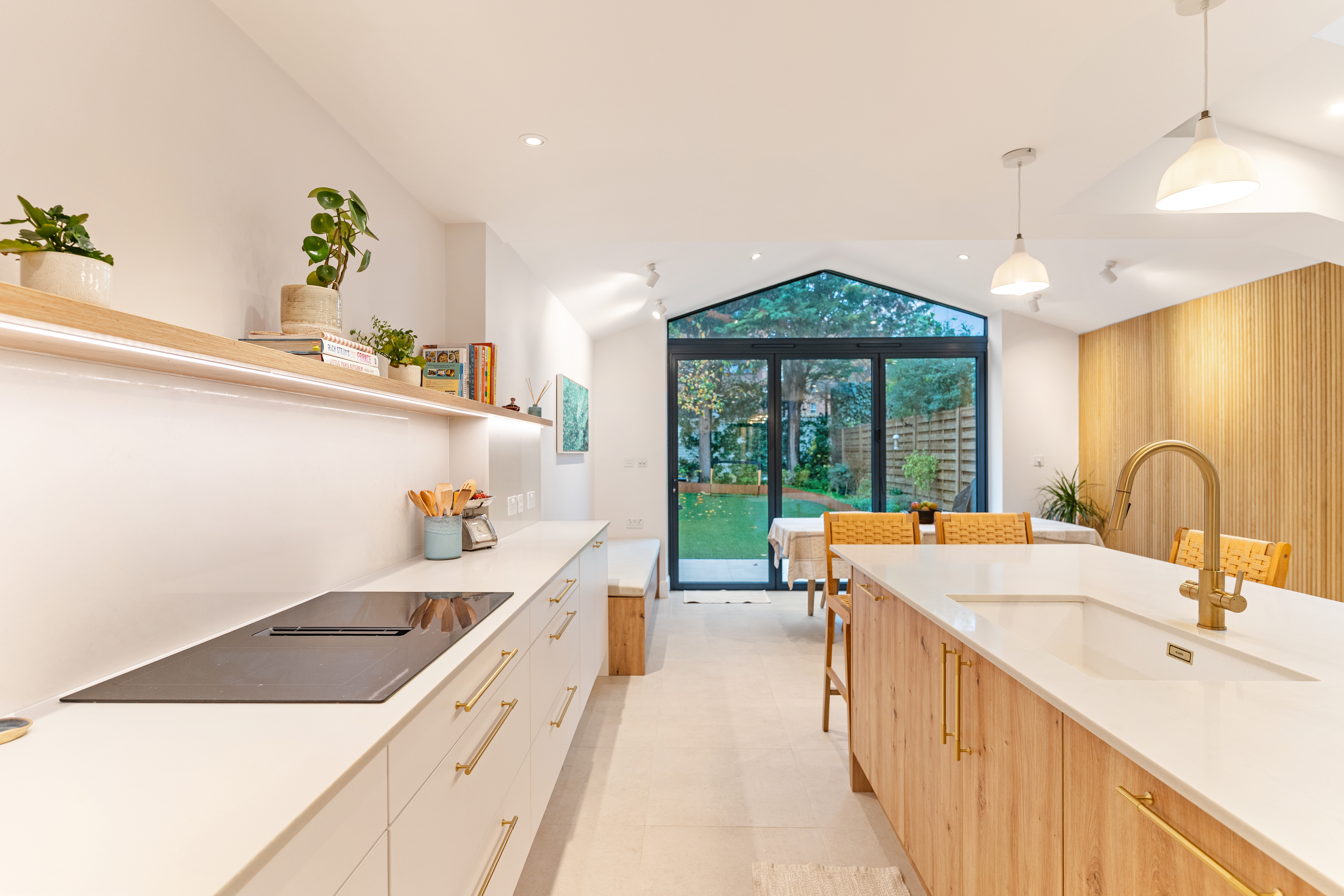 Bright open plan kitchen with skylights and natural wood island