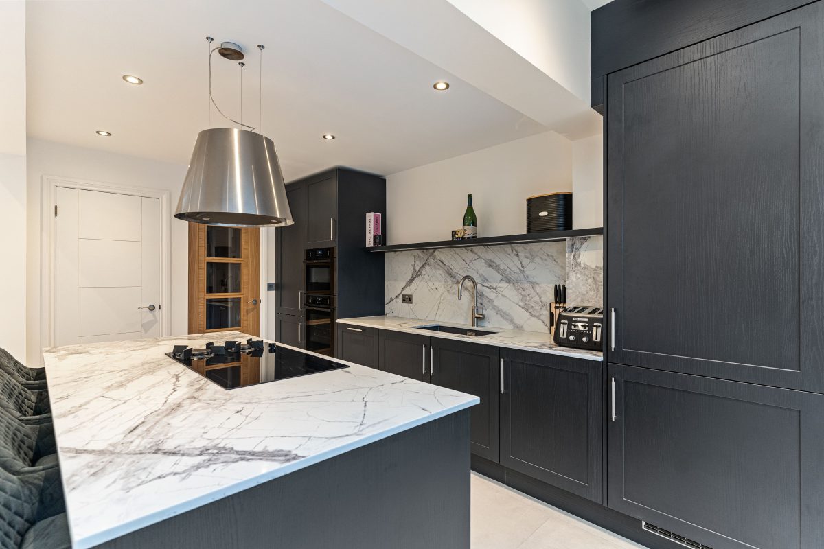 Black kitchen with a light worktop
