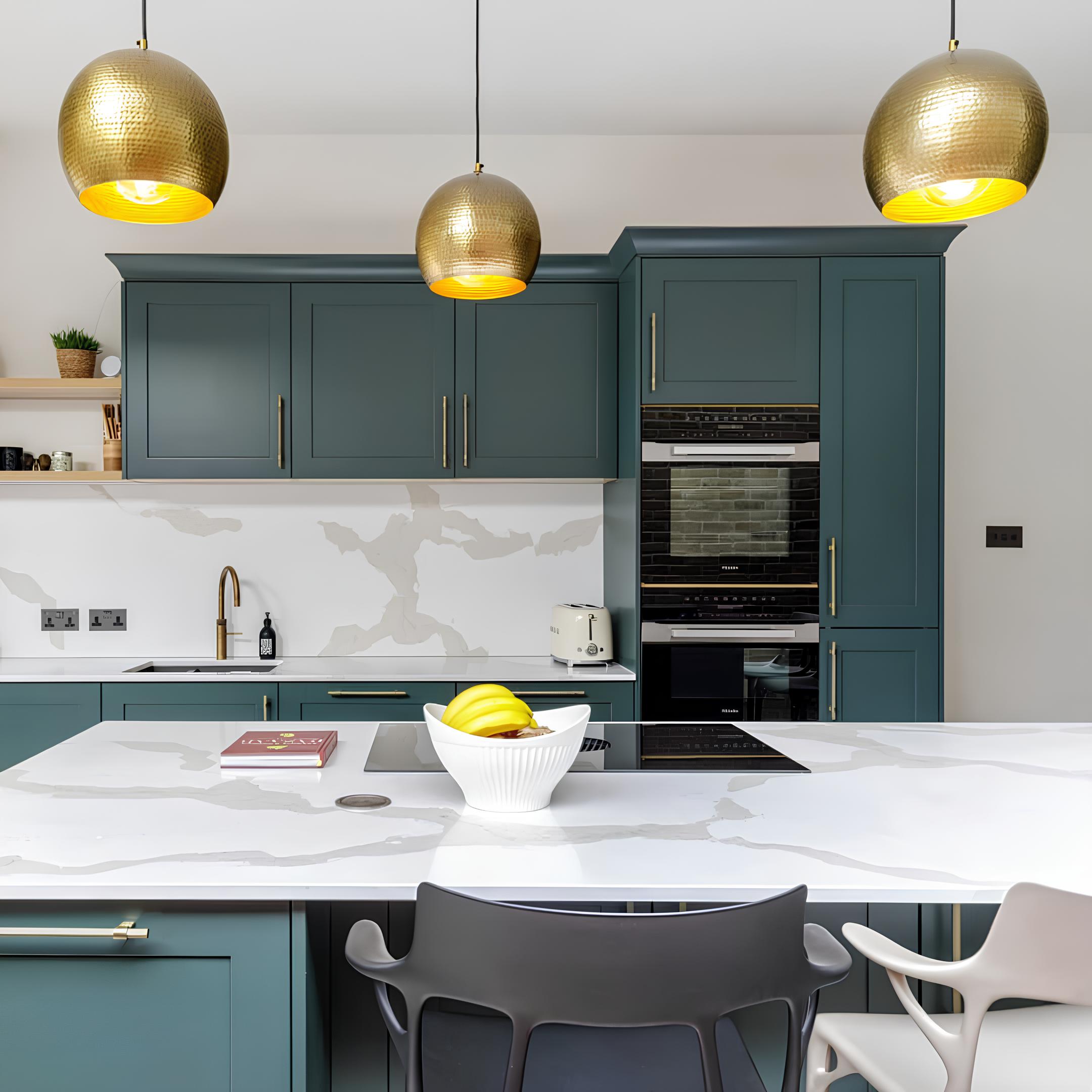 Modern kitchen featuring stylish blue cabinets, a white marble worktop, and elegant gold pendant lights. A fruit bowl with bananas sits on the island, while an Arch KBB team member is present, showcasing a contemporary kitchen design ideal for homeowners seeking inspiration for kitchen worktops.